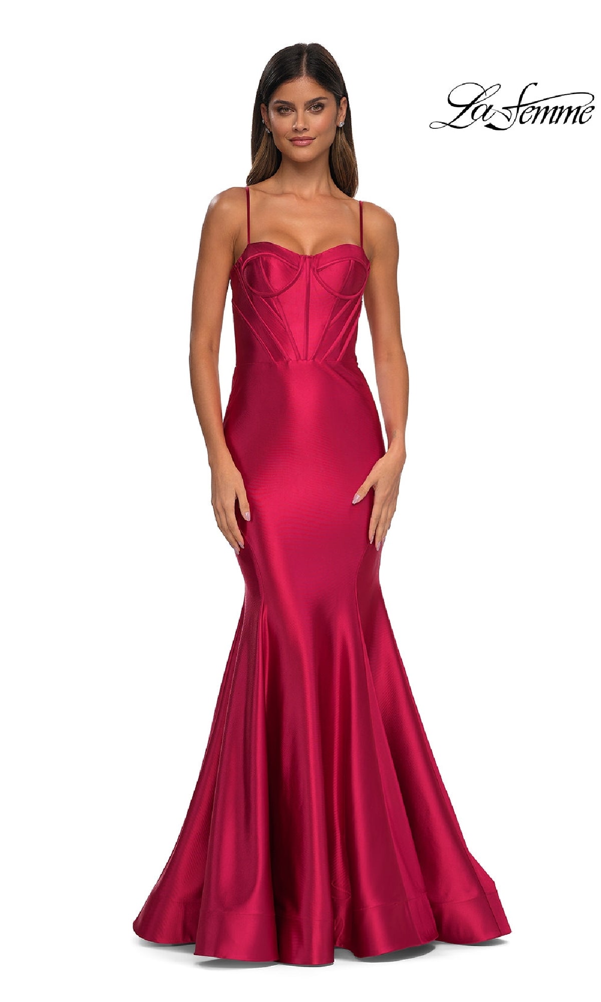 A woman models the Long Corset Mermaid Prom Dress: La Femme 32555, a fitted, floor-length deep pink satin gown with thin straps and structured bodice; La Femme logo appears in the top right corner.